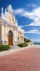 Fototapeta premium This beautiful colonial structure boasts yellow and white detailing, brightening while large windows and lush greenery enhance its charm on a sunny day