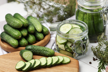 Fresh cucumbers on light table, closeup. Preparation for pickling