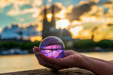 Close up of lensball at sunset in Cologne with Cologne Cathedral in background, Germany.