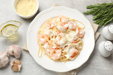 Delicious pasta with shrimps served on light table, flat lay