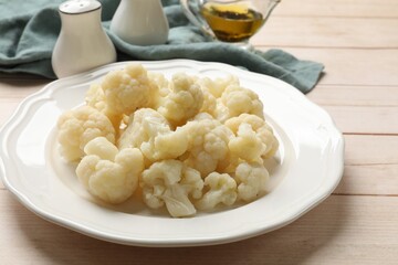 Tasty cooked cauliflower on white wooden table, closeup