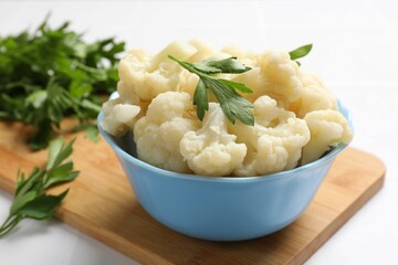 Tasty cauliflower with parsley on white table, closeup
