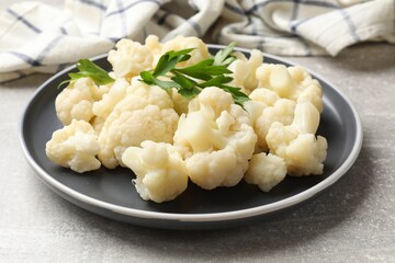 Tasty cauliflower with parsley on grey table, closeup