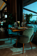 Stylish table setting in a cozy restaurant with dishes and furniture.in a minimalist style