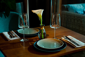 Stylish table setting in a cozy restaurant with dishes and furniture.in a minimalist style