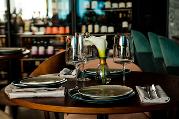Stylish table setting in a cozy restaurant with dishes and furniture.in a minimalist style