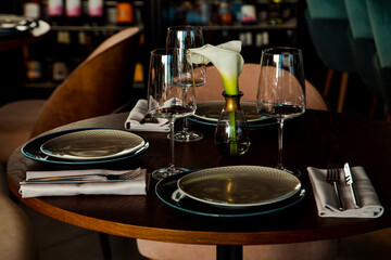 Stylish table setting in a cozy restaurant with dishes and furniture.in a minimalist style