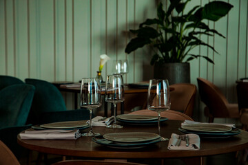 Stylish table setting in a cozy restaurant with dishes and furniture.in a minimalist style
