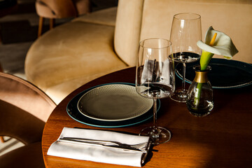 Stylish table setting in a cozy restaurant with dishes and furniture.in a minimalist style