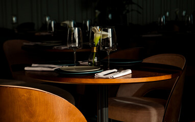 Stylish table setting in a cozy restaurant with dishes and furniture.in a minimalist style