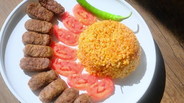 A balkan traditional meatball dish cevapi on wooden table in close-up