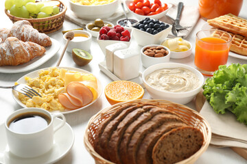 Tasty breakfast. Many different food and drinks on light table