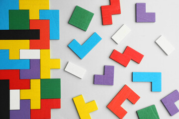 Obraz premium Colorful wooden puzzle pieces on light grey background, top view