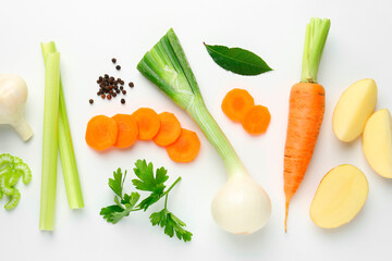 Pieces of fresh ripe carrots, vegetables and spices on white background, flat lay