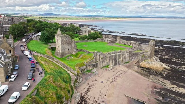 Aerial view of Coastal, episcopal castle ruins with secret passages and dungeon in Scotland. St Andrews Castle residence of Scotland's leading bishop, cathedral and town of St Andrews view.