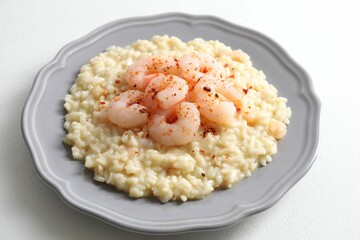Delicious risotto with shrimps and cheese on white table, closeup
