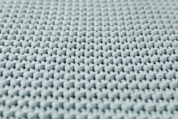 Naklejka premium Texture of light blue knitted fabric as background, closeup