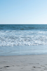 Ocean waves on the beach with a beautiful blue sky in Los Angeles