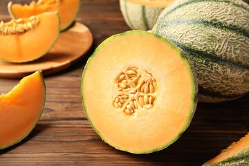 Cut Cantaloupe melon on wooden table, closeup