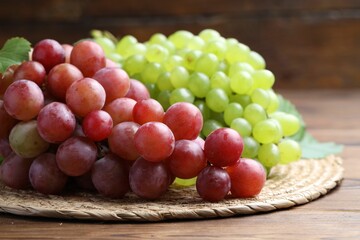 Fresh ripe grapes on wooden table, closeup