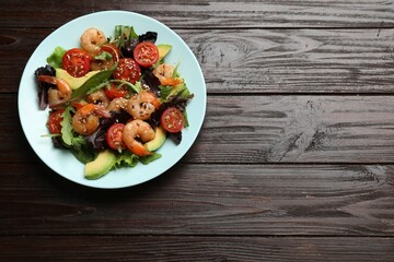 Delicious shrimp salad on wooden table, top view. Space for text