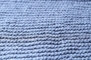 Texture of blue knitted fabric as background, closeup