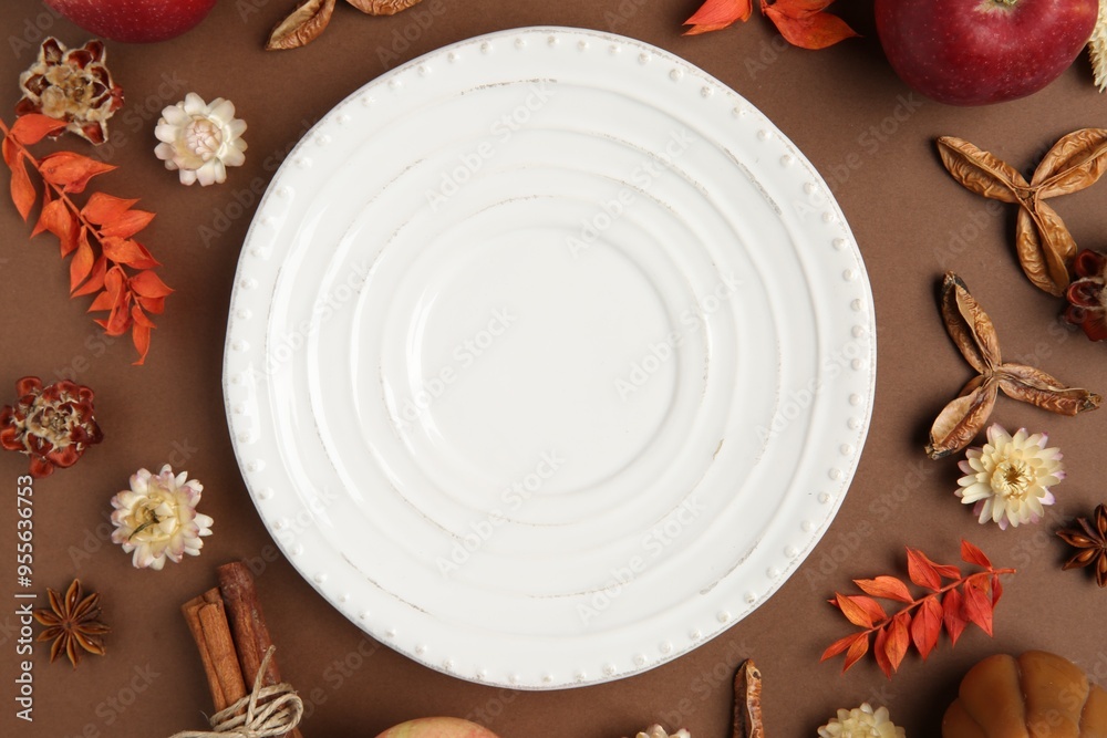 Canvas Prints Stylish table setting. Plate and autumn decor on brown background, flat lay