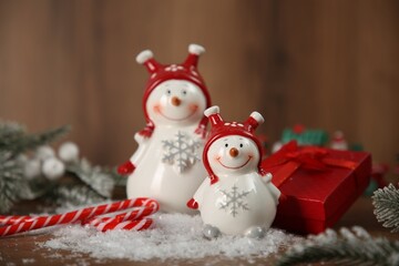Cute decorative snowmen and other Christmas decor on table