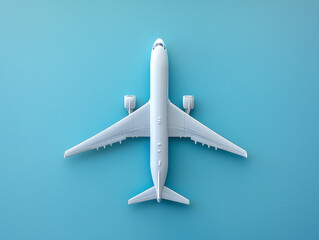 Top view of a white airplane on a blue background. 