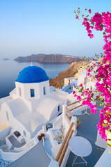 traditional greek village Oia of Santorini, with blue domes of churches and village roofs, Greece © neirfy