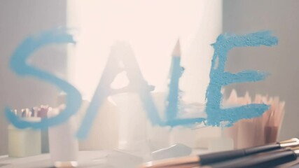 The word "Sale" in stencil-style blue text on a cosmetics-themed background with makeup palettes and brushes in soft focus - Powered by Adobe
