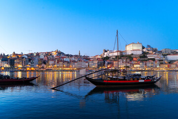 Obraz premium Picturesque, colorful view at old town Porto at sunset over Douro river. Oporto, touristic mediterranean city