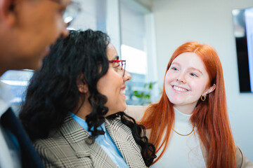 Naklejka premium Smiling young businesspeople teamwork engaged in a collaborative discussion in an office. Close up