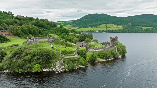 Aerial view of Urquhart Castle Large, ruined castle overlooking Loch Ness. The fortress situated on a headland, medial ruin in the Scottish Highlands laid out around two main enclosures on the shore.