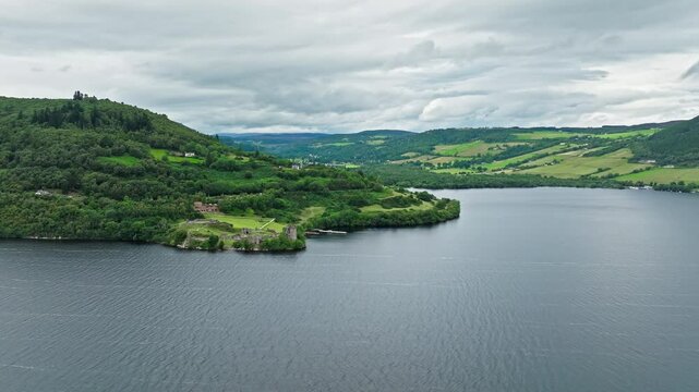 Aerial view of Urquhart Castle Large, ruined castle overlooking Loch Ness. The fortress situated on a headland, medial ruin in the Scottish Highlands laid out around two main enclosures on the shore.