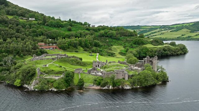 Aerial view of Urquhart Castle Large, ruined castle overlooking Loch Ness. The fortress situated on a headland, medial ruin in the Scottish Highlands laid out around two main enclosures on the shore.