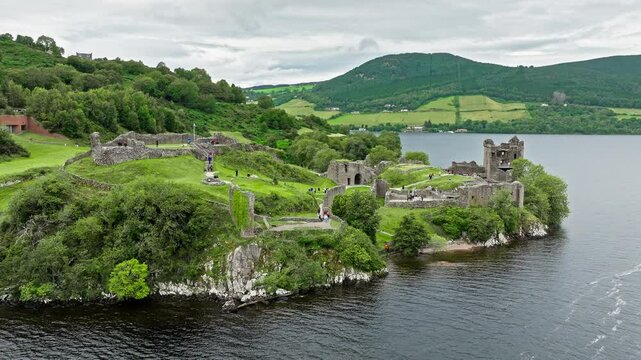 Aerial view of Urquhart Castle Large, ruined castle overlooking Loch Ness. The fortress situated on a headland, medial ruin in the Scottish Highlands laid out around two main enclosures on the shore.