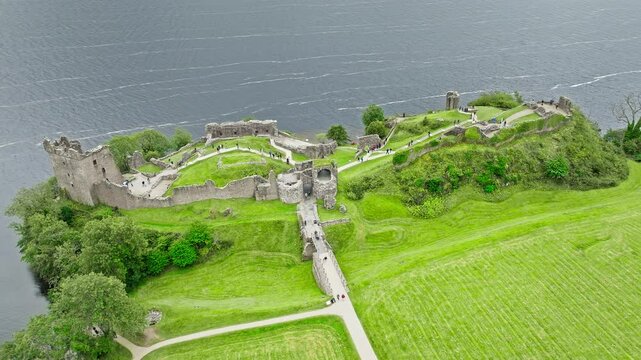 Aerial view of Urquhart Castle Large, ruined castle overlooking Loch Ness. The fortress situated on a headland, medial ruin in the Scottish Highlands laid out around two main enclosures on the shore.