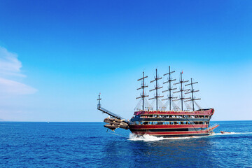 Tourist ship at sea on coast of Alanya. Landscape view of Mediterranean coast, Alanya, Turkey.