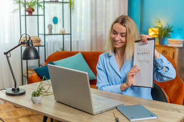 Caucasian businesswoman freelancer making online presentation video laptop call education lessons for remote study student classes at office workplace. Female demonstrates graphic analytics at home.