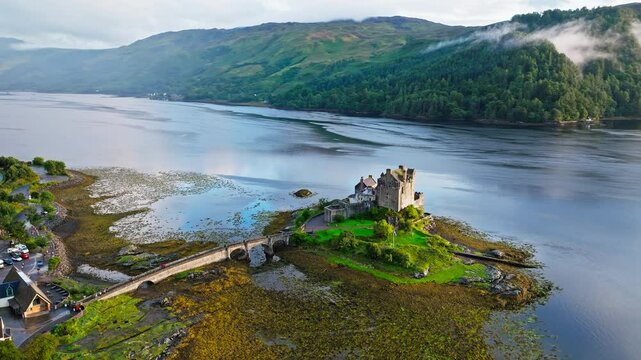 Aerial view of Eilean Donan Castle with long arched bridge and lochside setting. Scottish icon and a popular tourist attraction in the Highlands overlooking the Isle of Skye. 