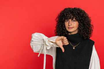 Dislike. Upset unhappy Caucasian woman showing thumbs down sign gesture, expressing discontent,...