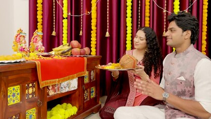Indian Couple Doing Arti of Ganesh Ji and Laxmi Ji on Diwali Festival