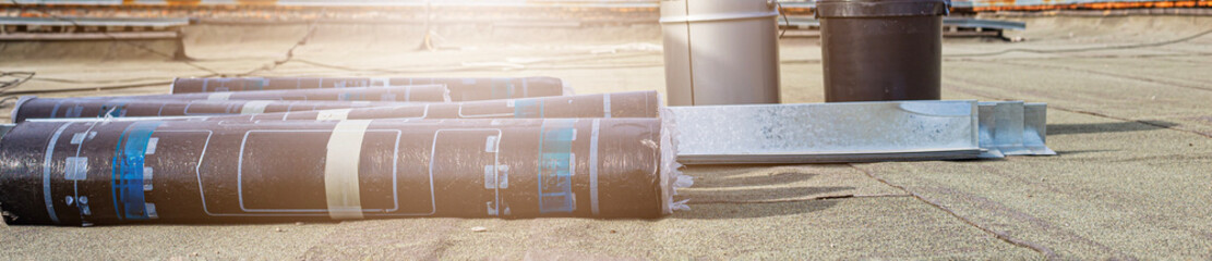 roll roofing material and primer prepared for repair of bitumen and asphalt roofs © Torkhov