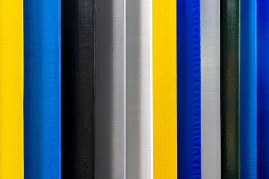 variety of tarps or fabrics for outdoor areas, in different colors, widely used for covering warehouses in agriculture