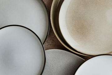 Top view of modern various ceramic plates on a kitchen table, cooking concept.