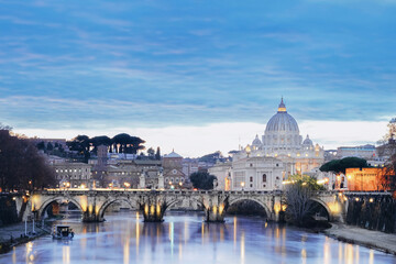 Fototapeta premium The River Tiber Flowing Under A Bridge At Twilight In Rome, Italy With A View Of Saint Peter's Basilica In The Background. Rome, Italy - 29.12.2021