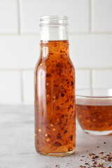 Sweet chili sauce in a bottle on kitchen counter 