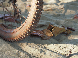 Mountain bike tyre, covered with dirt and sand. 