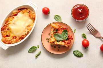 Baking dish and plate of pasta with tomato sauce on white background
